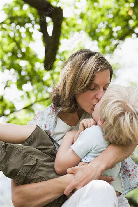 A Mother Holding and Kissing her Son